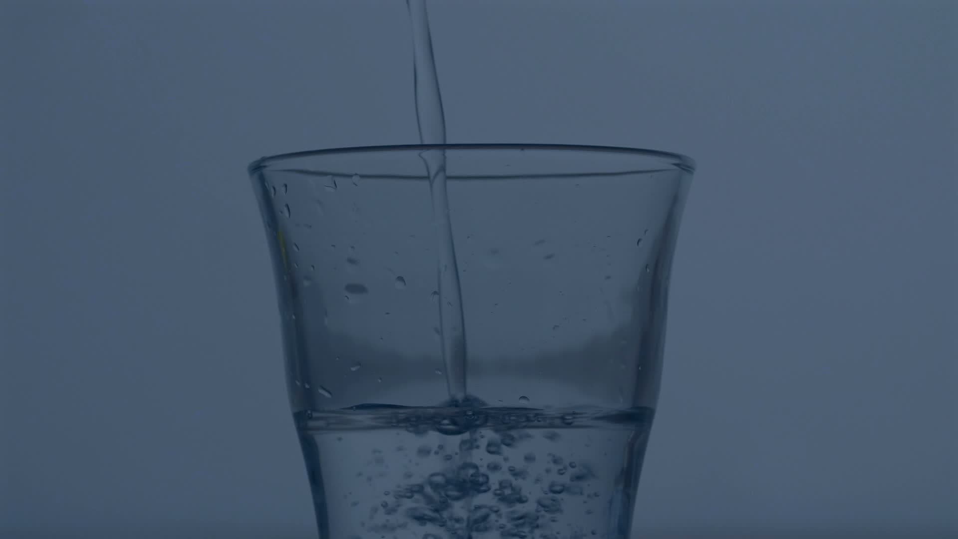 Water being poured into a clear glass